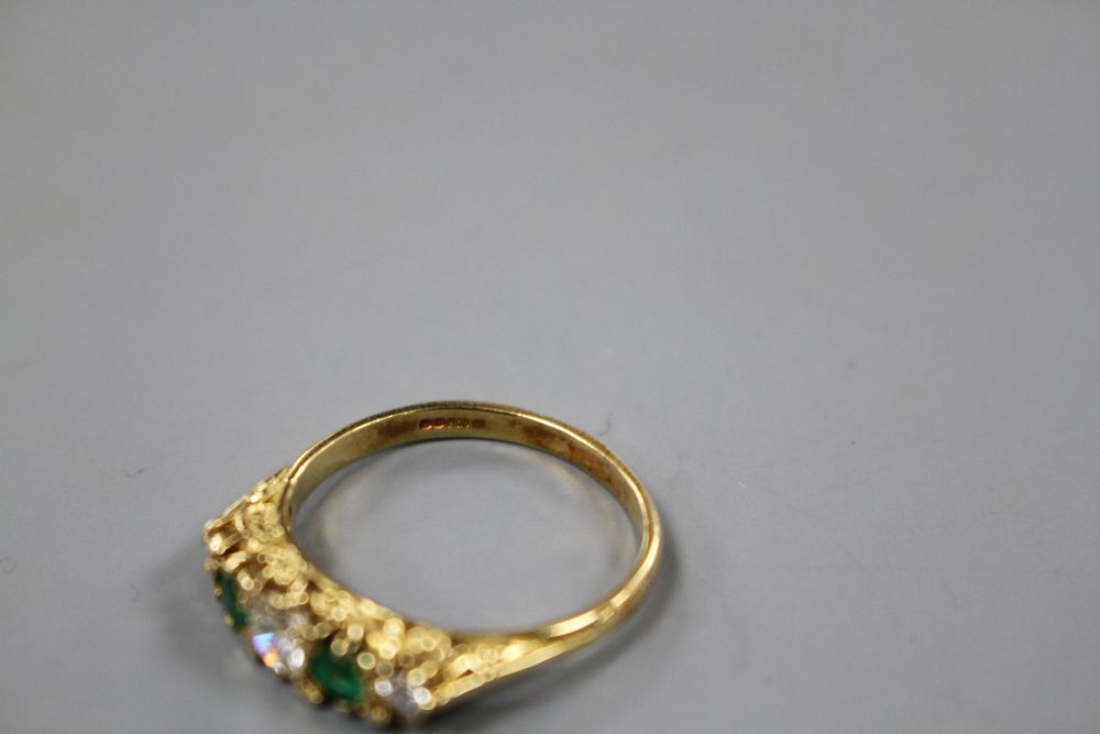 A modern Victorian style 18ct gold, two stone emerald and three stone diamond set half hoop ring,